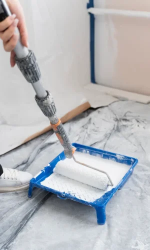 high-angle-contractor-painting-house-wall